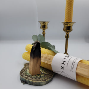 Palo Santo Smoking on a Hamsa with Beeswax Candles and Candle Sticks