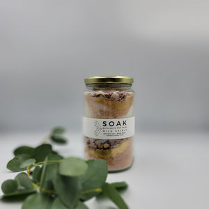 Magnesium Salt Soak with Rose Petals, Gold Mica and French Pink Clay. Product Front Feature Detail with Sprig of Eucalyptus 