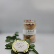 Load image into Gallery viewer, Magnesium Salt Soak with Rose Petals, Gold Mica and French Pink Clay. Product Front Lid Feature Detail with Sprig of Eucalyptus 
